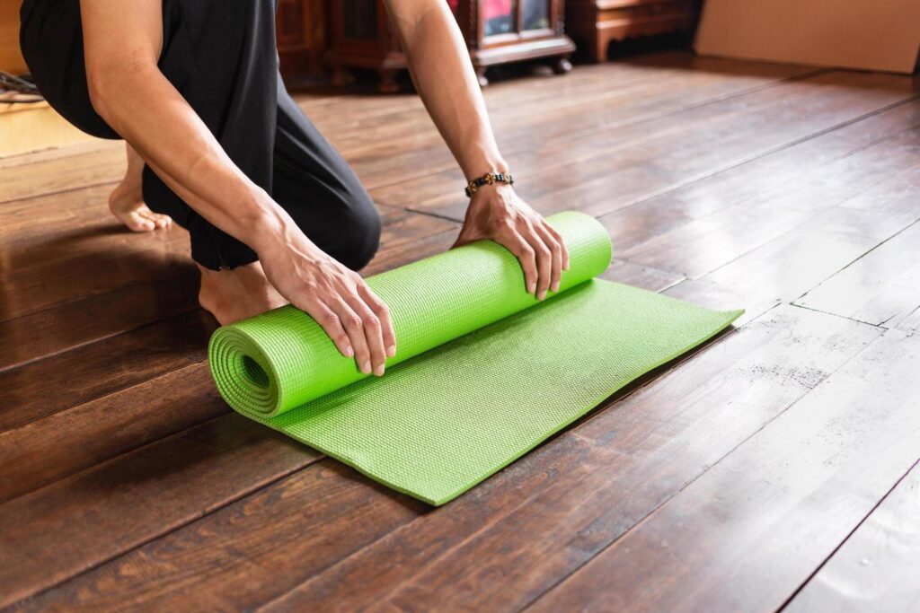 Man performing a plank on a yoga mat in a home gym, emphasizing daily discipline in fitness routines.